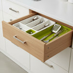 Expandable cutlery storage tray inside a kitchen drawer